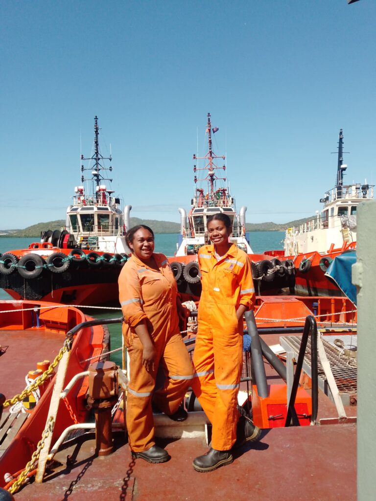 Natash Kema with one of her crew-mates during one of their break hours. Pacific Towing docking yard (Napanapa, Port Moresby)